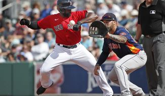 Boston Red Sox&#39;s Jackie Bradley Jr. gets back to first safely on a pickoff attempt to Houston Astros first baseman Nick Tanielu during a spring training baseball game, Thursday, March 5, 2020, in Fort Myers, Fla. (AP Photo/Elise Amendola)