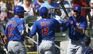Chicago Cubs&#39; Ian Happ (8) celebrates his home run against the Colorado Rockies with Kyle Schwarber (12) and Steven Souza Jr., right, during the first inning of a spring training baseball game Tuesday, March 3, 2020, in Scottsdale, Ariz. (AP Photo/Ross D. Franklin)