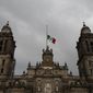 In this Sept. 9, 2017, file photo, a Mexican flag flies at half-mast on the Metropolitan Cathedral during three days of mourning following a deadly earthquake and hurricane, in Mexico City. (AP Photo/Marco Ugarte, File)