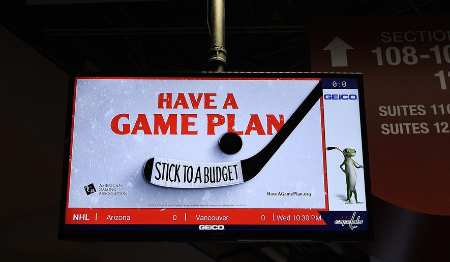 An ad for the American Gaming Association is seen tested on a screen after an NHL hockey game between the Washington Capitals and the Philadelphia Flyers, Wednesday, March 4, 2020, in Washington. The gambling industry is launching a campaign to urge sports bettors to wager responsibly, including setting and sticking to a budget, and learning thoroughly about anything on which they make a bet. The gaming association on Thursday launched its "Have A Game Plan" campaign in hockey arenas in Washington and Las Vegas. (AP Photo/Nick Wass)