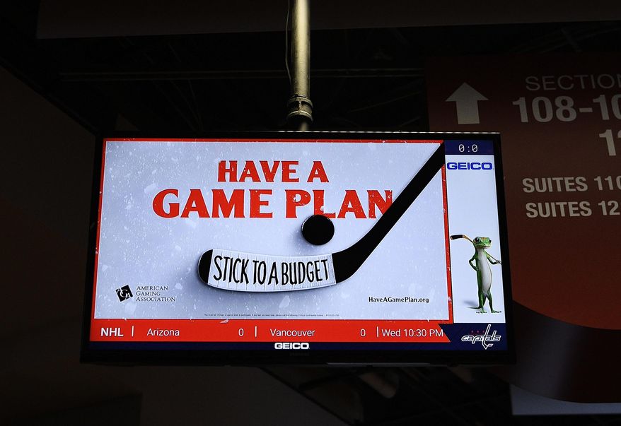 An ad for the American Gaming Association is seen tested on a screen after an NHL hockey game between the Washington Capitals and the Philadelphia Flyers, Wednesday, March 4, 2020, in Washington. The gambling industry is launching a campaign to urge sports bettors to wager responsibly, including setting and sticking to a budget, and learning thoroughly about anything on which they make a bet. The gaming association on Thursday launched its "Have A Game Plan" campaign in hockey arenas in Washington and Las Vegas. (AP Photo/Nick Wass)