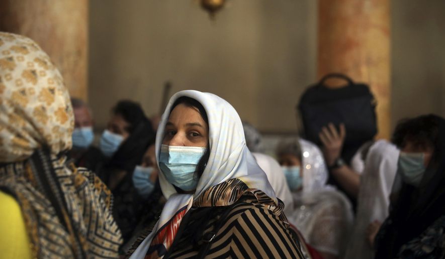 People visit the Church of the Nativity in Bethlehem, West Bank, Thursday, March 5, 2020. Palestinian authorities said the Church of the Nativity in Bethlehem, built atop the spot where Christians believe Jesus was born, will close indefinitely due to coronavirus concerns. (AP Photo/Mahmoud Illean)