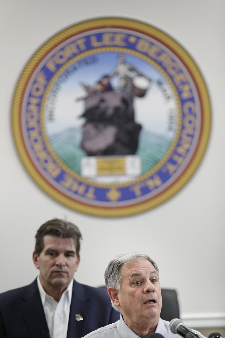 Bergen County Executive Jim Tedesco, right, speaks to reporters as Fort Lee mayor Mark Sokolich listens during a news conference in Fort Lee, N.J., Thursday, March 5, 2020. New Jersey now has its second positive test for the new coronavirus, Acting Gov. Sheila Oliver said Thursday. One of the people that has tested positive for the coronavirus was staying at his apartment in Fort Lee when he began to feel ill. (AP Photo/Seth Wenig)