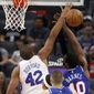 Philadelphia 76ers forward Al Horford, left, fouls Sacramento Kings forward Harrison Barnes, right, as he goes to the basket during the first quarter of an NBA basketball game in Sacramento, Calif., Thursday, March 5, 2020. (AP Photo/Rich Pedroncelli)