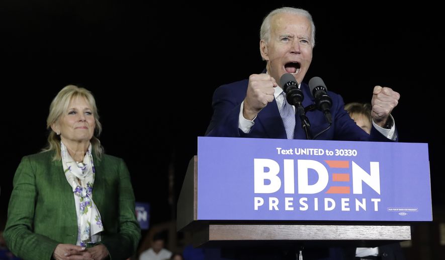 Democratic presidential candidate former Vice President Joe Biden, accompanied by his wife Jill, gestures as he speaks during a primary election night rally Tuesday, March 3, 2020, in Los Angeles. (AP Photo/Marcio Jose Sanchez)