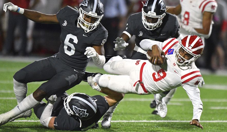 FILE - In this Friday, Oct. 25, 2019, file photo, Mater Dei quarterback Bryce Young is tackled after scrambling out of the pocket during a high school football game against St. John Bosco in Bellflower, Calif. Aside from being 2,000 miles away from his home in Southern California, the most challenging part of Alabama freshman quarterback Bryce Young's transition to college was dealing with two straight weeks of rainy weather in Tuscaloosa this winter. They don't get that in Pasadena, California. Otherwise, he's been too busy to be homesick. (Scott Varley/The Orange County Register via AP, File)