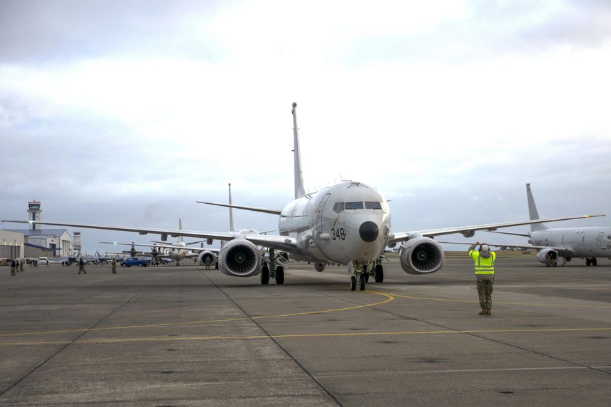 FILE - In this Oct. 23, 2019, file image provided by the U.S. Navy, a sailor assigned to the Grey Knights of Patrol Squadron (VP) 46 signals the pilot in the flight station of a P-8A Poseidon during a pre-flight check, in Oak Harbor, Wash. China's Defense Ministry said Friday, March 6, 2020, that a report one of its navy ships fired a laser last month at a U.S. Navy surveillance plane P-8A Poseidon circling overhead does not “accord with reality."(Austin Ingram/U.S. Navy photo by Mass Communication Specialist 2nd Class via AP, File)