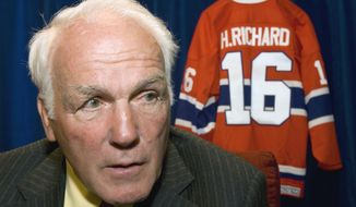 FILE - In this June 1, 2007, file photo, former Montreal Canadiens&#39; Henri Richard responds to questions in Ottawa, Ontario. Henri Richard, the speedy center who won a record 11 Stanley Cups with the Montreal Canadiens, died Friday, March 6, 2020. He was 84. His death was announced by the team. Richard had Alzheimer&#39;s disease. (Paul Chiasson, Canadian Press via AP)