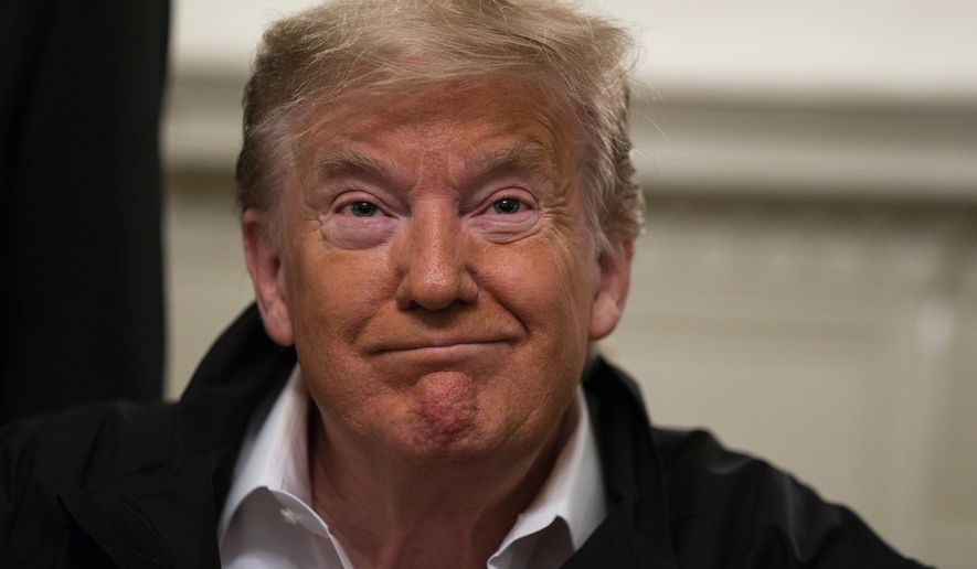 President Donald Trump listens to a question as he talks to reporters during a signing of a spending bill to combat the coronavirus, at the White House, Friday, March 6, 2020, in Washington. (AP Photo/Evan Vucci)