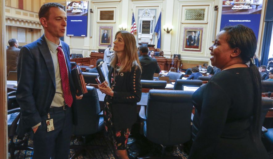 House Speaker Del. Eileen Filler-Corn, D-Fairfax, center talks with Del. Marcus Simon, D-Fairfax, left, and House majority leader Del. Charniele Herring, D-Alexandria, right, during a break in the session at the Capitol Friday March 6 , 2020, in Richmond, Va. (AP Photo/Steve Helber)