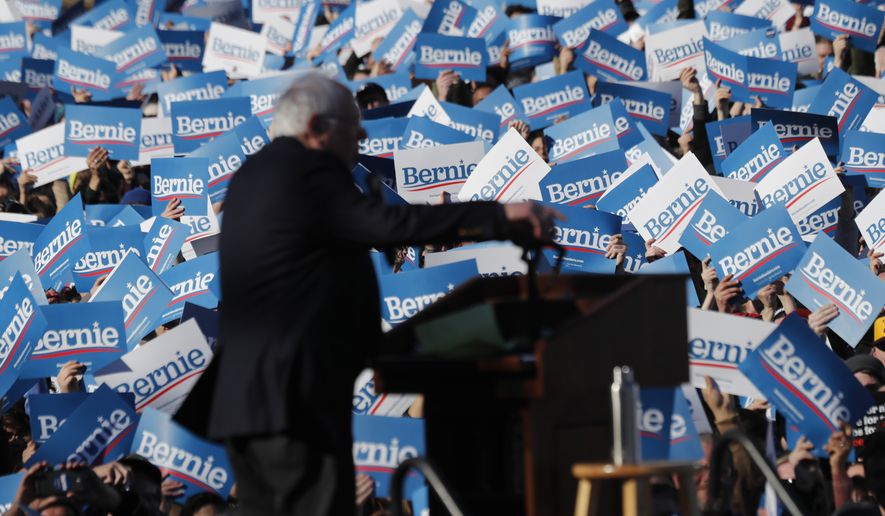 Supporters of Democratic presidential candidate Sen. Bernie Sanders, I-Vt., wave their campaign signs at a rally in Chicago's Grant Park Saturday, March 7, 2020. (AP Photo/Charles Rex Arbogast)