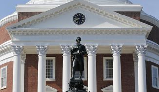 FILE - In this Aug. 6, 2018, file photo, a statue of Thomas Jefferson stands in front of the Rotunda on the campus of the University of Virginia in Charlottesville, Va. For the first time since World War II, Charlottesville won’t honor the Founding Father’s birthday this spring. Instead, the city will celebrate the demise of the institution with which Jefferson increasingly has become associated: slavery. (AP Photo/Steve Helber, File)