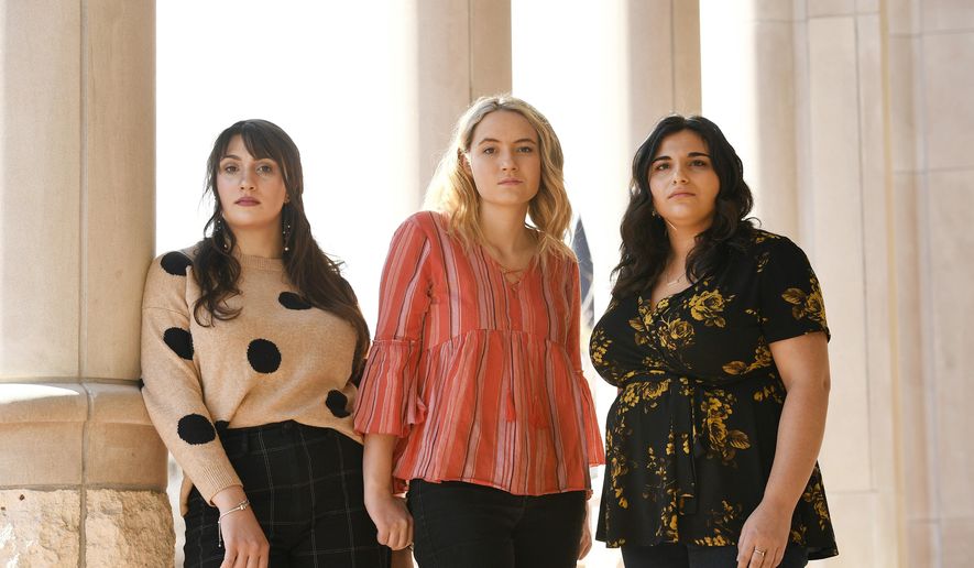 In this Feb. 26, 2020 photo, University of Denver students, from left, Madeline Membrino, Grace Wankelman and Shannon Saul pose for a portrait outside of the library at the university campus in Denver. The trio, who are all survivors of sexual assault, started an Instagram account called WecanDUbetter where DU students can anonymously share their stories of sexual assault on their college campus. The account has been so successful that they have started a second national account called The Do Better Campaign that they hope will target students on all college campuses nationwide. (Helen H. Richardson/The Denver Post via AP)