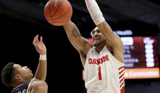 Dayton&#x27;s Obi Toppin (1) dunks over George Washington&#x27;s Jameer Nelson Jr (12) during the first half of an NCAA college basketball game Saturday, March 7, 2020, in Dayton, Ohio. (AP Photo/Tony Tribble)