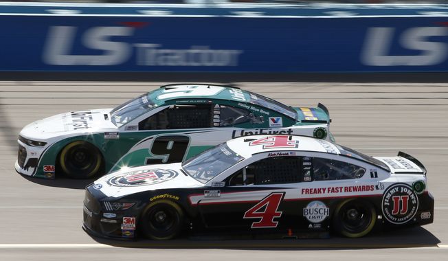 Kevin Harvick (4) races Chase Elliott (9) for the lead through Turn 4 during a NASCAR Cup Series auto race at Phoenix Raceway, Sunday, March 8, 2020, in Avondale, Ariz. (AP Photo/Ralph Freso) **FILE**