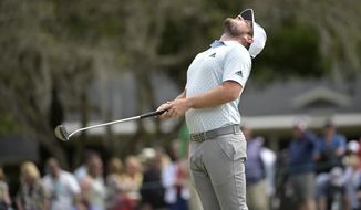 Tyrrell Hatton, of England, stretches before putting on the second green during the final round of the Arnold Palmer Invitational golf tournament, Sunday, March 8, 2020, in Orlando, Fla. (AP Photo/Phelan M. Ebenhack)