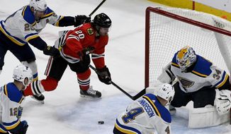 St. Louis Blues goaltender Jake Allen (34), defenseman Carl Gunnarsson (4) and left wing Alexander Steen (20) defend against Chicago Blackhawks left wing Brandon Saad (20) during the second period of an NHL hockey game between the Chicago Blackhawks and the St. Louis Blues on Sunday March 8, 2020, in Chicago. (AP Photo/Matt Marton)