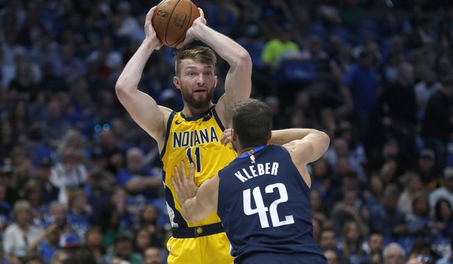 Indiana Pacers forward Domantas Sabonis (11) looks to pass over Dallas Mavericks forward Maxi Kleber (42) during the first half of an NBA basketball game, Sunday, March 8, 2020, in Dallas. (AP Photo/Ron Jenkins)