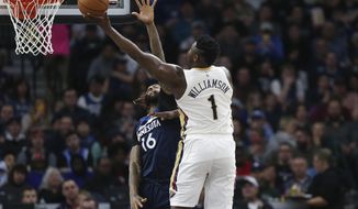 New Orleans Pelicans&#39; Zion Williamson (1) shoots over Minnesota Timberwolves&#39; James Johnson in the first half of an NBA basketball game Sunday, March 8, 2020, in Minneapolis. (AP Photo/Stacy Bengs)