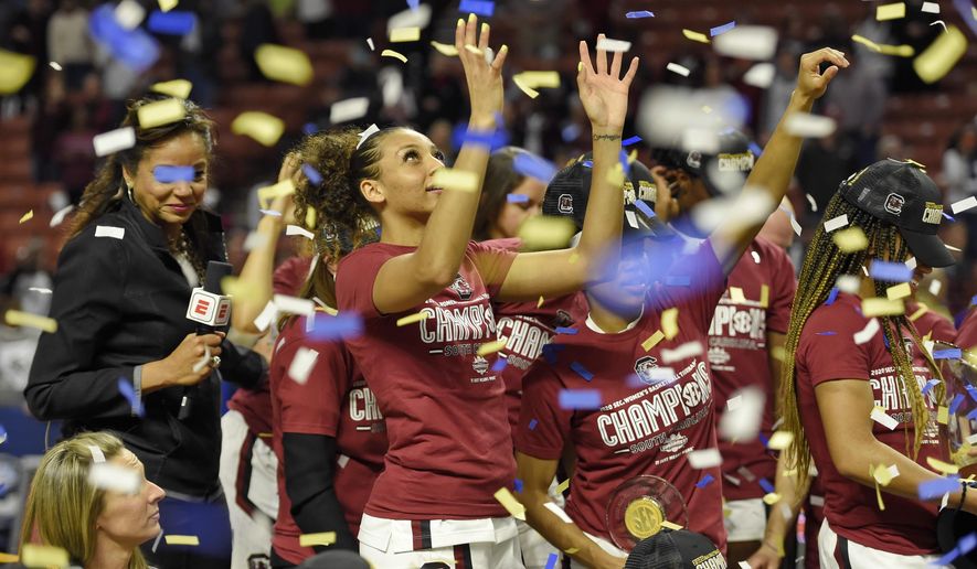 South Carolina's Mikiah Herbert-Harrigan grabs for confetti after defeating Mississippi State in a championship match at the Southeastern Conference women's NCAA college basketball tournament in Greenville, S.C., Sunday, March 8, 2020. (AP Photo/Richard Shiro)