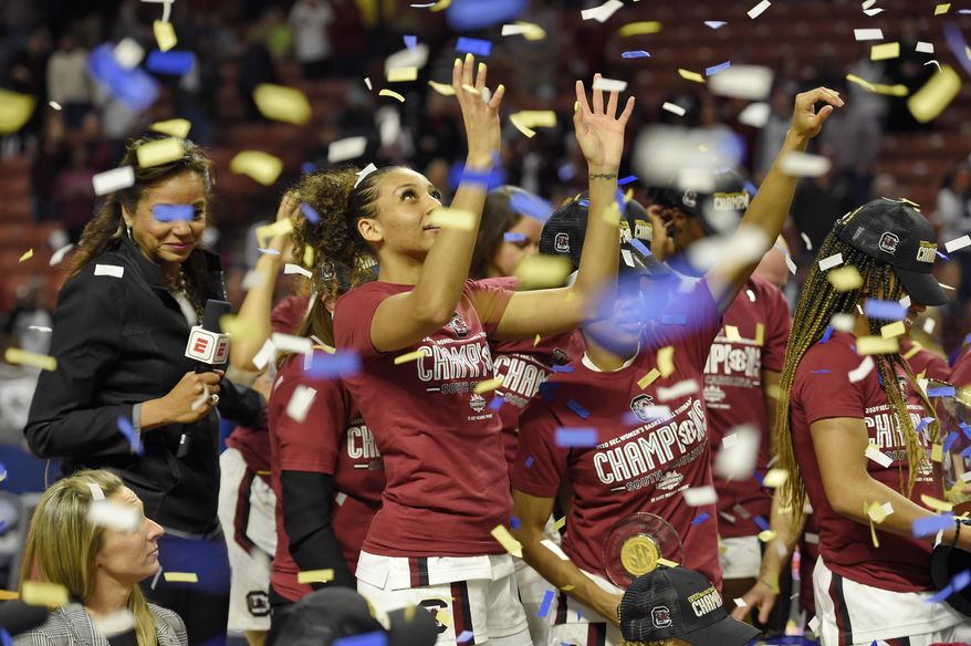 South Carolina's Mikiah Herbert-Harrigan grabs for confetti after defeating Mississippi State in a championship match at the Southeastern Conference women's NCAA college basketball tournament in Greenville, S.C., Sunday, March 8, 2020. (AP Photo/Richard Shiro)