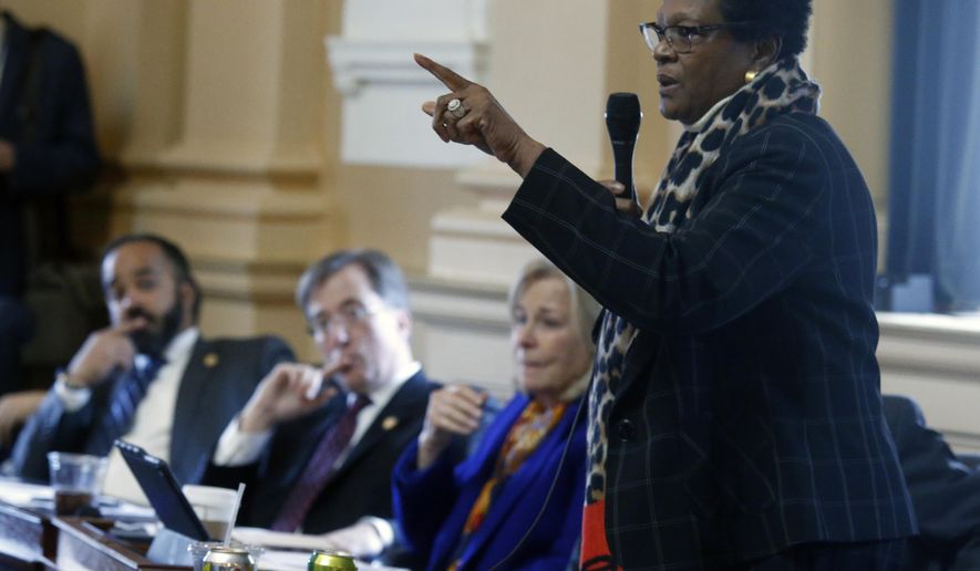 Del. Delores McQuinn, D-Richmond, right, gives an impassioned speech for passage of HB 1537, her bill that would allow the removal, relocation or altering memorials to war veterans, during the floor session of the Virginia House of Delegates inside the State Capitol in Richmond, VA Tuesday, Feb. 11, 2020. The bill passed, 53-46. Looking on are, from left, Del. Jeff Bourne, D-Richmond, Del. Rip Sullivan, D-Fairfax and Del. Kathleen Murphy, D-Fairfax. (Bob Brown/Richmond Times-Dispatch via AP)