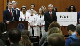 Gov. Ralph Northam, left, speaks during a news conference on the state&#39;s preparedness for the coronavirus at the Capitol in Richmond, Va., on Wednesday, March 4, 2020. (AP Photo/Steve Helber)