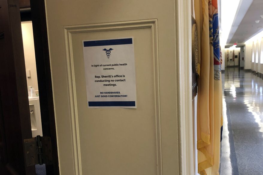 A sign regarding coronavirus is posted on the office of Rep. Mikie Sherrill, D-N.J., on Capitol Hill in Washington, Monday, March 9, 2020. (Associated Press/Laurie Kellman)