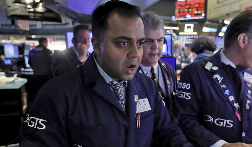 Specialist Dilip Patel, left, works at his post on the floor of the New York Stock Exchange, Monday, March 9, 2020. The Dow Jones Industrial Average sank 7.8%, its steepest drop since the financial crisis of 2008, as a free-fall in oil prices and worsening fears of fallout from the spreading coronavirus outbreak seize markets. (AP Photo/Richard Drew)