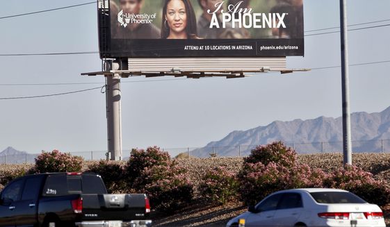 In this Nov 24, 2009, file photo, a University of Phoenix billboard is shown in Chandler, Ariz. The Department of Veterans Affairs is moving to bar new GI Bill students from enrolling at five universities, including the University of Phoenix, citing &amp;quot;advertising, sales or enrollment practices that are erroneous, deceptive or misleading.” (AP Photo/Matt York, File)