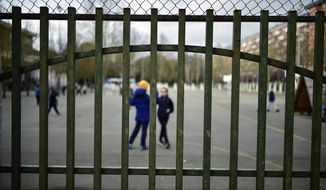 Young students play in a public school, in Vitoria, northern Spain, Monday, March 9, 2020. Health authorities in the Madrid region say that infections for the new coronavirus have more than doubled in the past 24 hours. (AP Photo/Alvaro Barrientos)