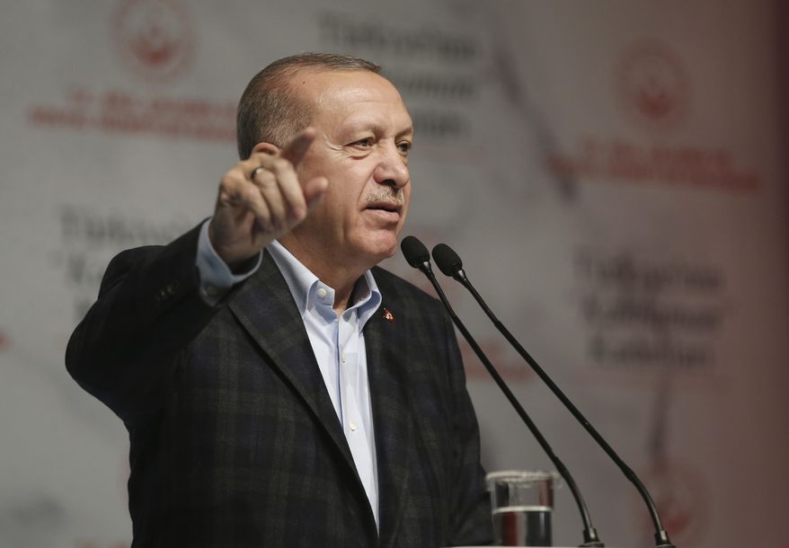 Turkey&#x27;s President Recep Tayyip Erdogan speaks during a meeting marking the International Women&#x27;s Day, in Istanbul, Sunday, March 8, 2020. Erdogan called on Greece to open its borders and allow the migrants to move on to other European countries. His deputy Fuat Oktay is at the right, and his wife Emine Erdogan at the left.(Presidential Press Service via AP, Pool)
