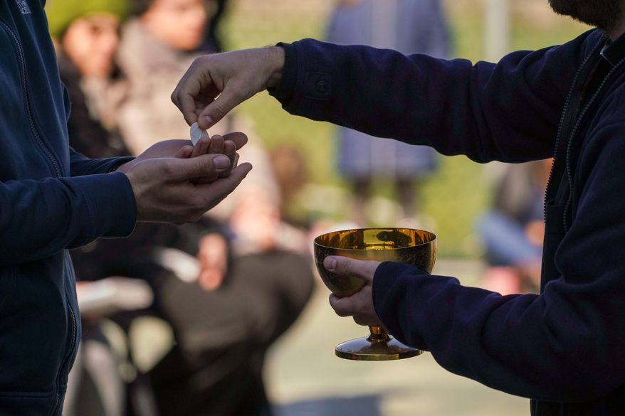 The crisis of how to respond to the spreading coronavirus — or how or even whether to take Holy Communion — has riled a number of parishes. (ASSOCIATED PRESS)