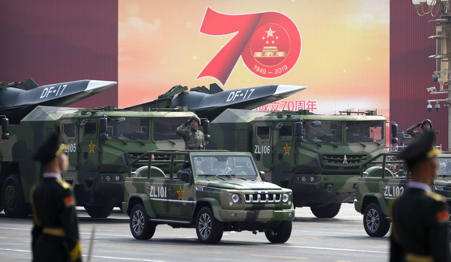 Chinese military vehicles carrying DF-17 ballistic missiles roll during a parade to commemorate the 70th anniversary of the founding of Communist China in Beijing, Tuesday, Oct. 1, 2019. Trucks carrying weapons including a nuclear-armed missile designed to evade U.S. defenses rumbled through Beijing as the Communist Party celebrated its 70th anniversary in power with a parade Tuesday that showcased China&#x27;s ambition as a rising global force. (AP Photo/Mark Schiefelbein) **FILE**