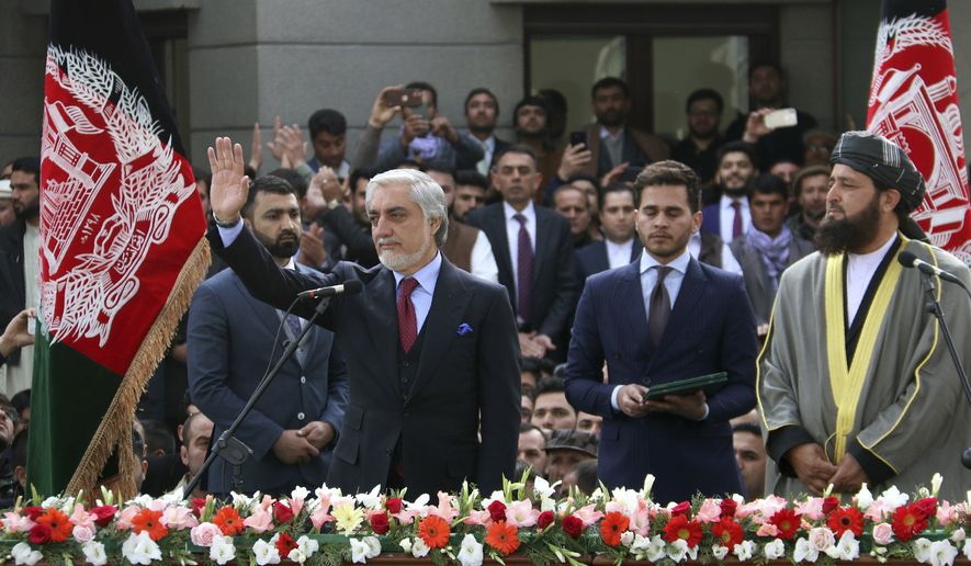 In this Monday, March 9, 2020, photo, Afghanistan&#39;s Abdullah Abdullah, front left, greets his supporters after being sworn in as president in Kabul, Afghanistan. Washington moved forward Tuesday on its peace deal with the Taliban, launching its troop withdrawal, while praising Afghanistan&#39;s newly installed President Ashraf Ghani&#39;s promise to proceed with a Taliban prisoner release as well as cobble together a team to start negotiations with the insurgent group. But the dueling presidential inaugurations a day earlier with Ghani&#39;s rival, Abdullah Abdullah also being sworn in as president is indicative of the uphill task facing Washington&#39;s peace envoy Zalmay Khalilzad as he tries to get Afghanistan&#39;s bickering leadership to come together.  (AP Photo)