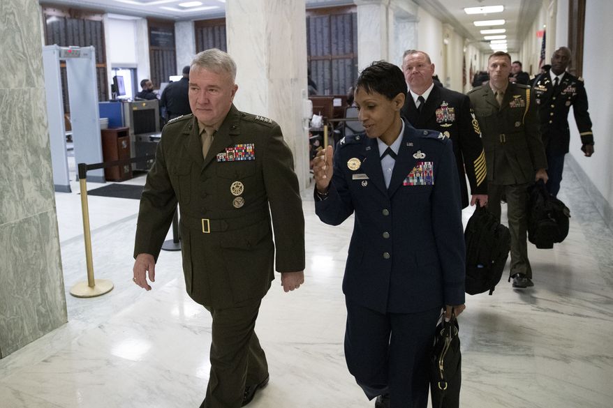 U.S. Marine Corps Gen. Kenneth McKenzie Jr., commander of U.S. Central Command, left, walks to a House Armed Services hearing, on Capitol Hill, Tuesday, March 10, 2020, in Washington. (AP Photo/Alex Brandon) ** FILE **