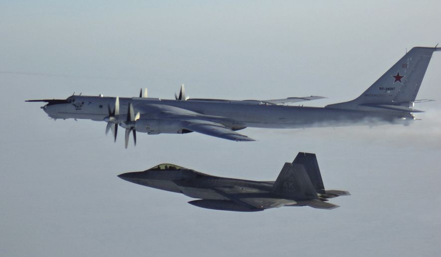 In this Monday, March 9, 2020, file photo released by the North American Aerospace Defense Command (NORAD), a Russian Tu-142 maritime reconnaissance aircraft, top right, is intercepted near the Alaska coastline. U.S. and Canadian aircraft intercepted and escorted two Russian jets that flew over the Beaufort Sea near the Alaska coastline, military officials said Tuesday. The Russian Tu-142 maritime reconnaissance aircraft were escorted by F-22 and CF-18 planes, the North American Aerospace Defense Command said in a release. The Russian jets never left international airspace during the duration of the four-hour flight on Monday, but did come within 50 miles of the Alaska coast. (North American Aerospace Defense Command  via AP)