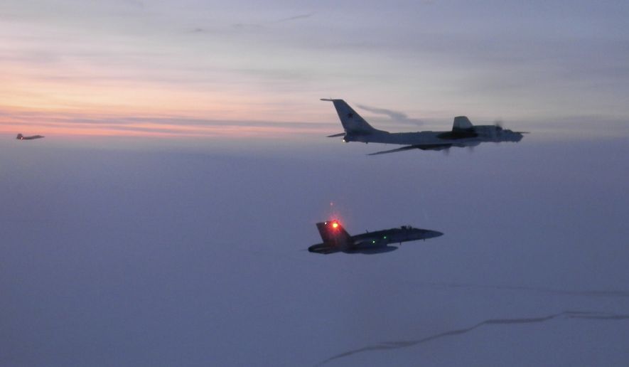 In this Monday, March 9, 2020, photo released by the North American Aerospace Defense Command (NORAD), a Russian Tu-142 maritime reconnaissance aircraft, top right, is intercepted near the Alaska coastline. U.S. and Canadian aircraft intercepted and escorted two Russian jets that flew over the Beaufort Sea near the Alaska coastline, military officials said Tuesday. The Russian Tu-142 maritime reconnaissance aircraft were escorted by F-22 and CF-18 planes, the North American Aerospace Defense Command said in a release. The Russian jets never left international airspace during the duration of the four-hour flight on Monday, but did come within 50 miles of the Alaska coast. (North American Aerospace Defense Command via AP)