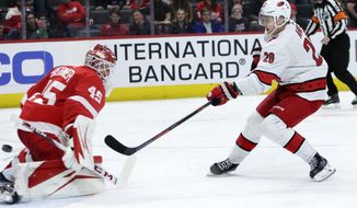 Carolina Hurricanes center Sebastian Aho (20) scores on Detroit Red Wings goaltender Jonathan Bernier (45) during the third period of an NHL hockey game Tuesday, March 10, 2020, in Detroit. (AP Photo/Duane Burleson)