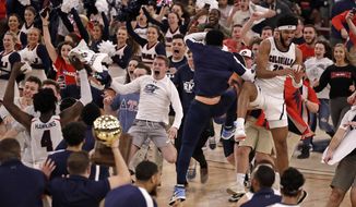 Robert Morris fans run onto the court as the team celebrates following a 77-67 win over St. Francis in an NCAA college basketball game for the Northeast Conference men&#39;s tournament championship in Pittsburgh, Tuesday, March 10, 2020. (AP Photo/Gene J. Puskar)