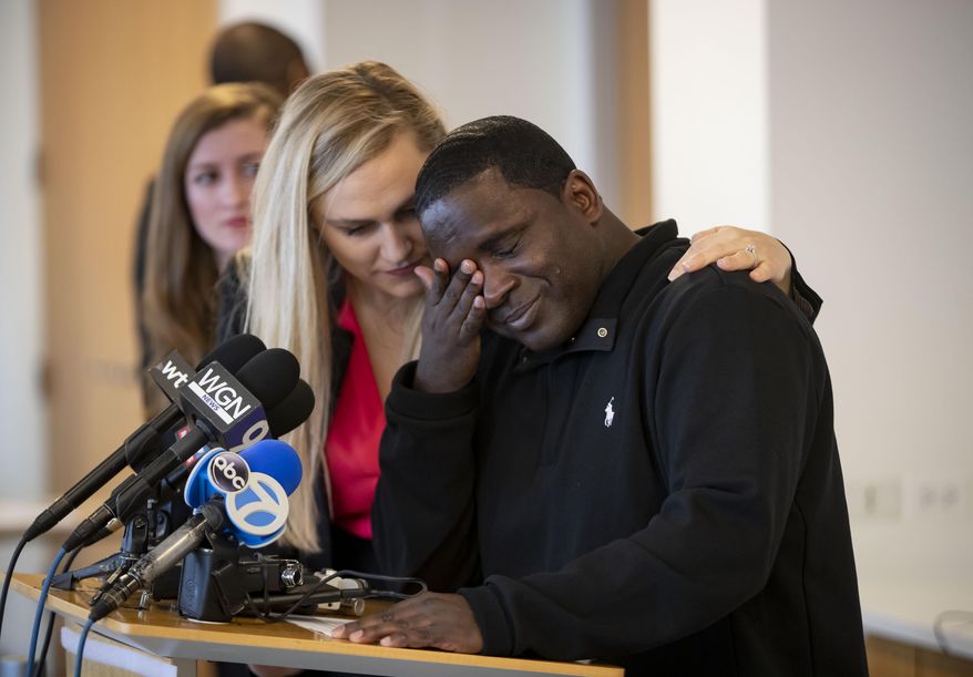 Anthony Gay becomes emotional while speaking March 10, 2020, about his years in solitary confinement, during a press conference Tuesday, March 10, 2020 in Chicago. Attorney Sarah Grady is consoling him. Gay went to prison in 1994 for stealing a dollar bill and a hat. Behavior problems, including self-mutilation, added to his sentence, and by the time he was released in August 2018, he had served 24 years in prison, 22 in solitary confinement. (Brian Cassella/Chicago Tribune via AP)