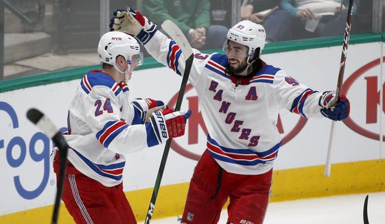 New York Rangers right wing Kaapo Kakko (24) celebrates with center Mika Zibanejad (93) after Kakko scored against the Dallas Stars during the second period of an NHL hockey game in Dallas, Tuesday, March 10, 2020. (AP Photo/Michael Ainsworth)