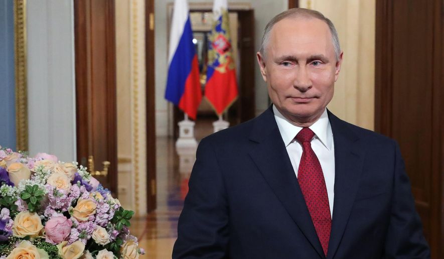 Russian President Vladimir Putin speaks to celebrate International Women&#39;s Day, in Moscow, Russia, Sunday, March 8, 2020. International Women&#39;s Day on March 8 is an official holiday in Russia, where men traditionally give flowers and gifts to female relatives, friends and colleagues. (Mikhail Klimentyev, Sputnik, Kremlin Pool Photo via AP)