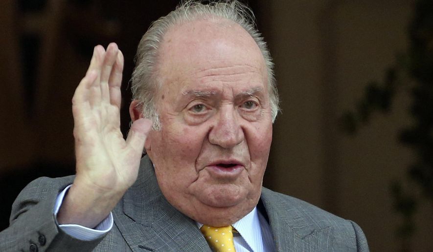 FILE - In this March 10, 2018 file photo, Spain's former monarch King Juan Carlos waves upon his arrival to the Academia Diplomatica de Chile, in Santiago. The Spanish parliament's decision-making board has rejected two proposals calling for the lower chamber to investigate whether former King Juan Carlos received millions of dollars in kick-back payments from Saudi Arabia. The proposals voted Tuesday March 10, 2020 were triggered by an ongoing investigation by Swiss prosecutors into an account reportedly operated for the Spanish monarch, including an alleged payment of 88 million euros (100 million dollars) by late Saudi King Abdullah in 2008. (AP Photo/Esteban Felix, File)