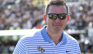 FILE - In this Nov. 2, 2019, file photo, Central Florida athletic director Danny White stands on the sideline at the team&#39;s NCAA college football game against Houston in Orlando, Fla. White has signed a five-year contract that will pay him more than $1 million annually. (AP Photo/Willie J. Allen Jr., File)