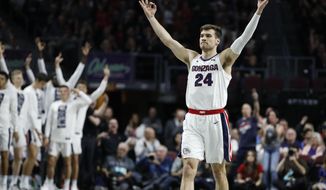 Gonzaga&#39;s Corey Kispert (24) celebrates after a teammate scored a 3-point shot against Saint Mary&#39;s in the first half of an NCAA college basketball game in the final of the West Coast Conference men&#39;s tournament Tuesday, March 10, 2020, in Las Vegas. (AP Photo/John Locher)
