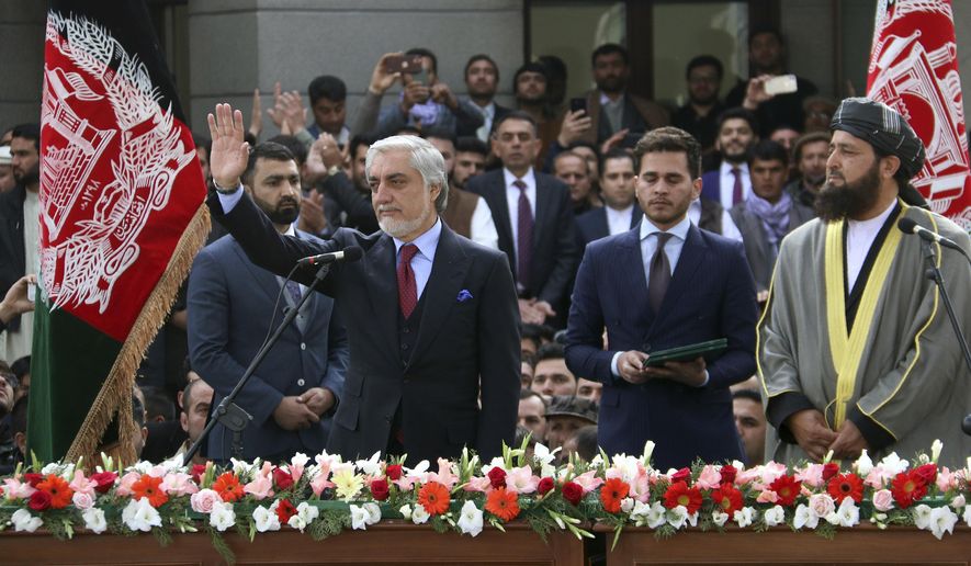 In this Monday, March 9, 2020, photo, Afghanistan&#39;s Abdullah Abdullah, front left, greets his supporters after being sworn in as president in Kabul, Afghanistan. Washington moved forward Tuesday on its peace deal with the Taliban, launching its troop withdrawal, while praising Afghanistan&#39;s newly installed President Ashraf Ghani&#39;s promise to proceed with a Taliban prisoner release as well as cobble together a team to start negotiations with the insurgent group. But the dueling presidential inaugurations a day earlier with Ghani&#39;s rival, Abdullah Abdullah also being sworn in as president is indicative of the uphill task facing Washington&#39;s peace envoy Zalmay Khalilzad as he tries to get Afghanistan&#39;s bickering leadership to come together.  (AP Photo)