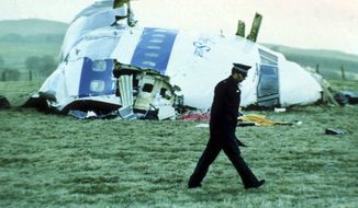 In this December 1988 file photo, a police officer walks past the wreckage in Lockerbie, Scotland, of Pan Am Flight 103 from London to New York. Scotland&#39;s criminal appeals body said Wednesday, March 11, 2020, that the family of the Libyan man jailed for the 1988 bombing of an airliner over the Scottish town of Lockerbie can launch a posthumous appeal against his conviction. (AP Photo/File)