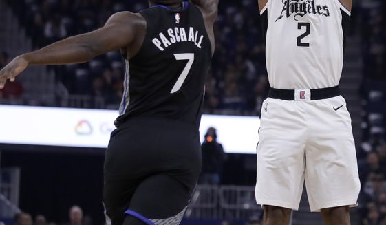 Los Angeles Clippers&#39; Kawhi Leonard, right, shoots against Golden State Warriors&#39; Eric Paschall (7) during the first half of an NBA basketball game Tuesday, March 10, 2020, in San Francisco. (AP Photo/Ben Margot)