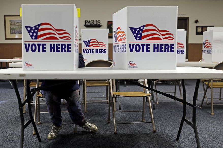 A voter fills in a ballot in the presidential primary election at the the Summit View Church of the Nazarene Tuesday, March 10, 2020, in Kansas City, Mo. The polling place served two precincts as voters who were scheduled to vote at a nearby senior living facility were directed to vote at the church after the facility backed out due to coronavirus concerns. (AP Photo/Charlie Riedel)
